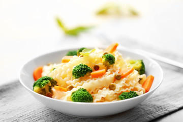 Delicious cold pasta salad in bowl on the table closeup