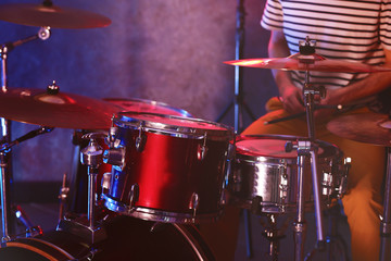 Obraz na płótnie Canvas Drummer playing on drum set on stage.