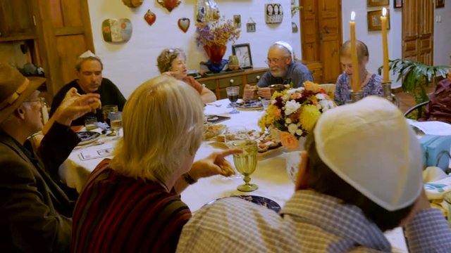 Hand held of people eating matzah at a Passover seder