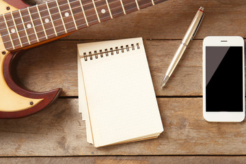 Notebook and smartphone on wooden background