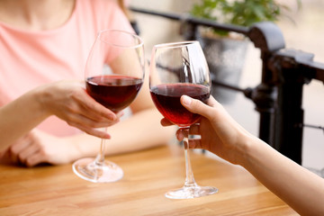 Young women drinking wine in cafe