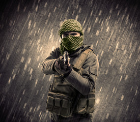 Armed terrorist man with mask on rainy background