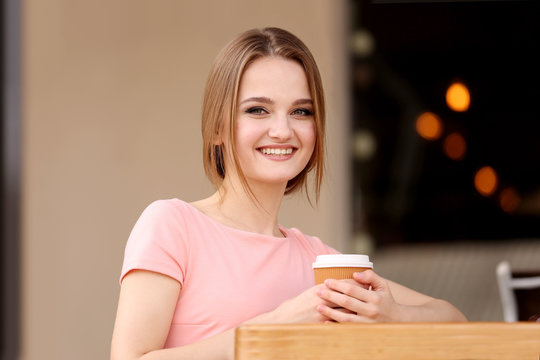 Young woman drinking coffee in cafe