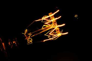 Illuminated light bulb on black background