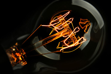 Illuminated light bulb on black background