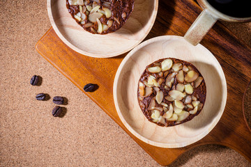 Homemade delicious fresh chocolate and almonds cake on wooden ta