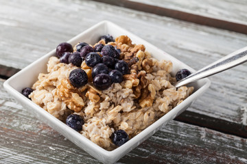 Oatmeal with chia seeds, brown sugar, blueberries, walnuts, and milk