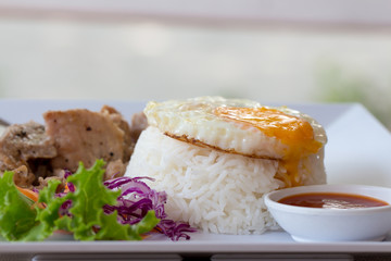 Fried egg on cooked rice with garlic pork 