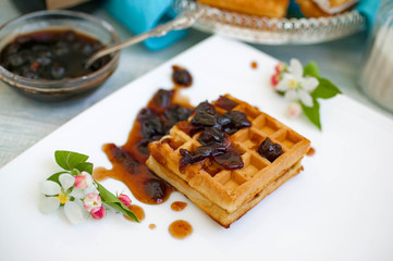 the Vienna wafers with cherry jam on a wooden table. vintage and retro tone