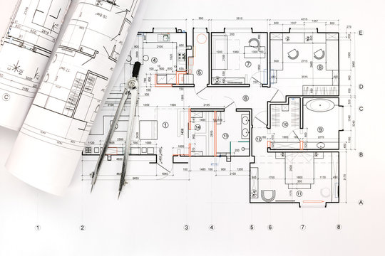 architectural blueprint rolls with drawing compass