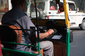 Fototapeta na wymiar Driver riding Autorickshaw