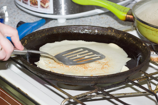 cooking pancakes in a frying pan