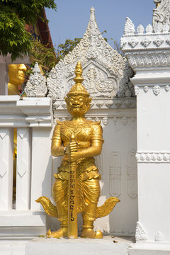 Ancient statue of the evil demon guarding the passage to the Buddha sculpture. Wat Seetharam, Bangkok