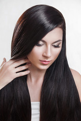 Naklejka premium Hair. Beautiful brunette girl . Healthy long hair .