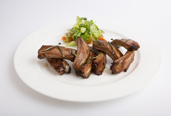 Fried ribs with salad