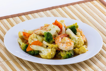 Vegetable fried with shrimp on white plate