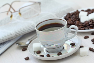 Cup of black coffee and newspapper
