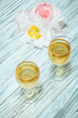 Two glasses of white wine and flowers