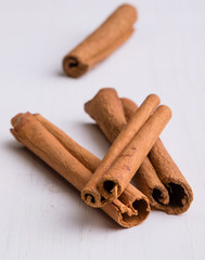 cinnamon sticks on white table