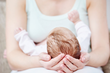 Obraz na płótnie Canvas Motherhood. newborn baby on mother hands