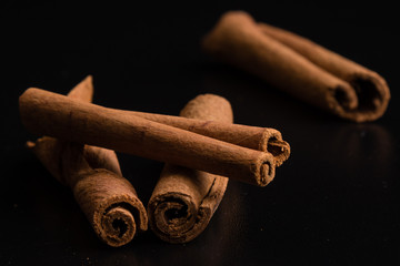 cinnamon sticks on black table - 111224146