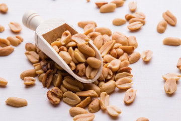 peanuts on wooden scoop