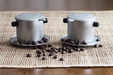 Two coffee makers on placemat. Vietnam style
