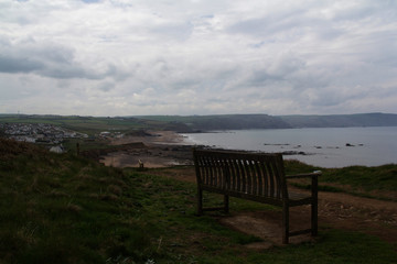 Fototapeta na wymiar Bench over looking the coast neaar Bude, Cornwall