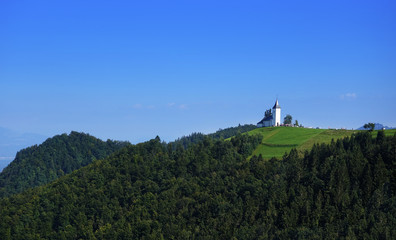 Church of St. Primoz near Jamnik with Alps, Slovenia, Europe