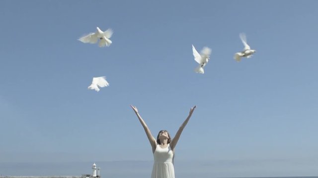Happy Woman Releasing A Pigeons