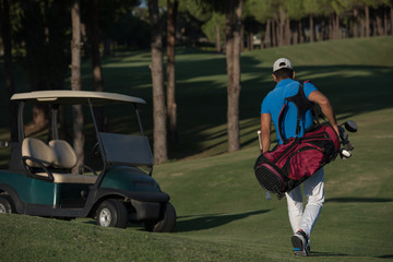 golfer  walking and carrying golf  bag