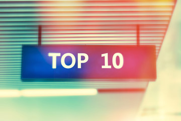Word TOP 10  on advertising board with shiny bright colors