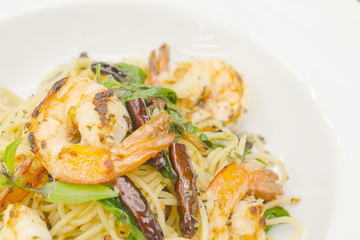 Tasty spicy spaghetti with shrimp on white plate