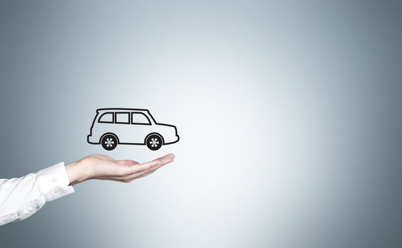 Businessman hand with car icon - Powered by Adobe