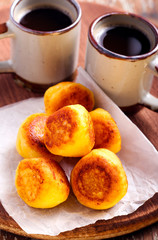 Vanilla ricotta fritters and cups of coffee