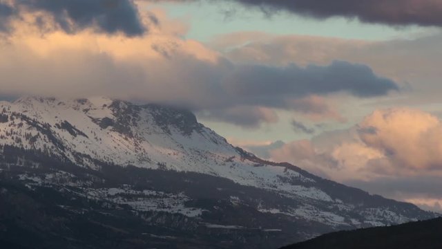 Winter sunset on the Chabrieres Needles (Aiguilles de Chabrieres) with passing clouds in the Ecrins National Park. Southern French Alps