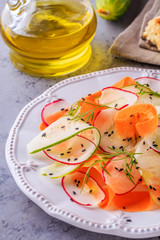 Vegetarian salad of carrot, cucumber and radish.