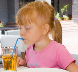 Children drinking fruit juice in cafe