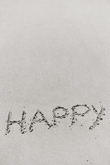Happy sign on the beach background