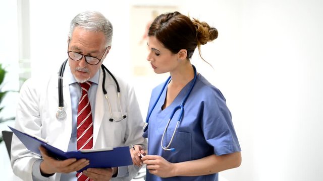 Doctor and nurse discussing a case history