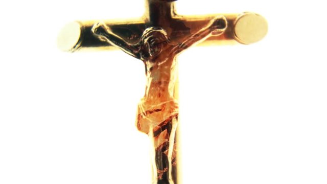 A statue of Jesus Christ on the cross, isolated on white background, with a fire pyre as an overlay; zooming and rotating until the details are clear.