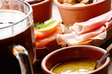 Tapas of salmon, mussels, jamon and olives with beer