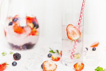 Glass with water and Strawberry. Summer drink with berries and ice cubes. Detox drink, diet and health food concept.