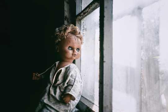 old doll near the window