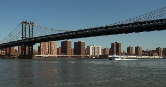 Boat passing beneath the Iconic Manhattan Bridge. 