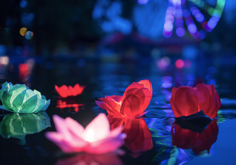 The glowing lanterns on the water