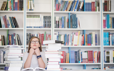 female student study in library, using tablet and searching for