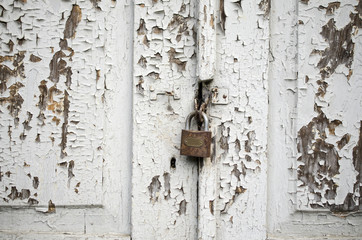 rusty lock on a white shabby door