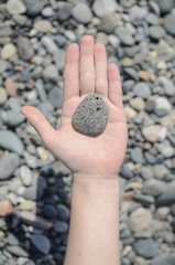 stone in hand, stone beach, beach with pebbles