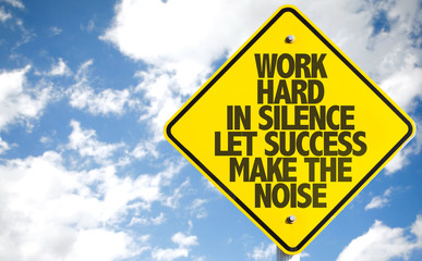 Work Hard in Silence Let Success Make the Noise sign with sky background